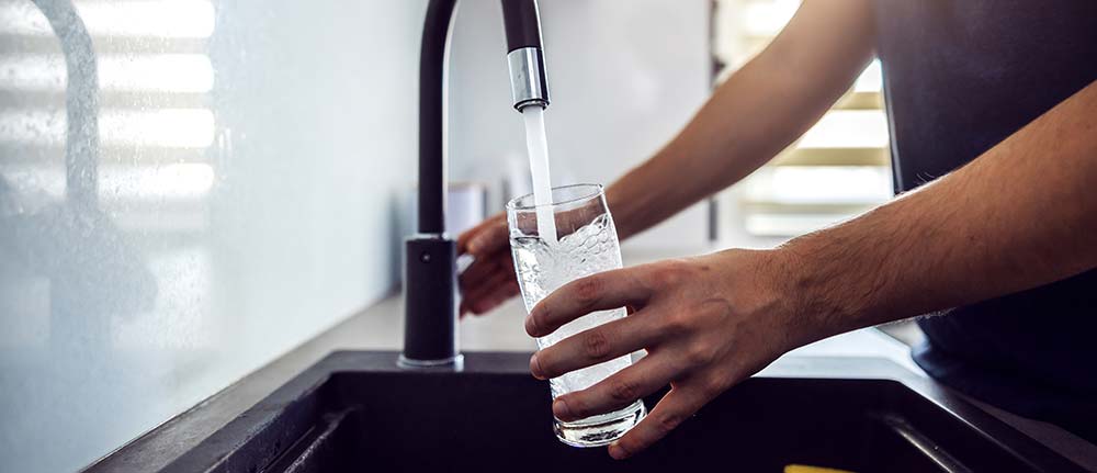 Filling glass in sink